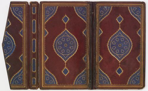 Inside of a mahogany-coloured leather book binding with flap laid flat open with simple decorative motifs. Both sides of the cover are a mirror image, with a central lapis lazuli medallion and corner decoration inside a double-framed gold border.