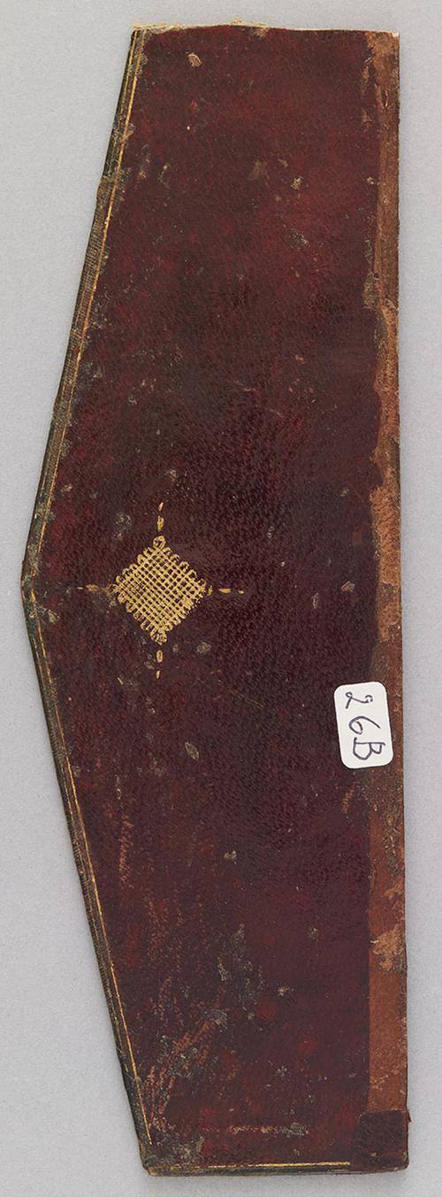 Inside of book binding flap, that is a mahogany red with a small gold lined ornament. 