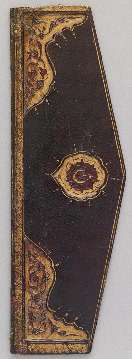 Outside of a dark-brown leather book binding flap. There is a gilt embossed medallion, gilt embossed border with corner ornamentation. The corner ornamentation as well as the medallion have red floral decorations. 