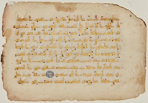 Fine kufic script in gold on vellum, with 10 lines per page, letter-pointing of very thin, diagonal dashes in light brown ink, vocalisation of red, blue and green dots, tenth verses marked within the text with abjad letters on gold kufic surrounded by a floral roundel in blue.