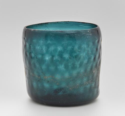 Blue/Green glass beaker of cylindrical form with a rounded honeycomb design.