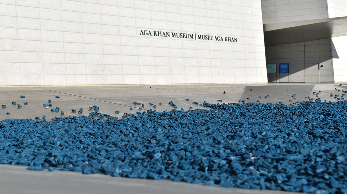 An exterior reflecting pool filled with pieces of blue mulch