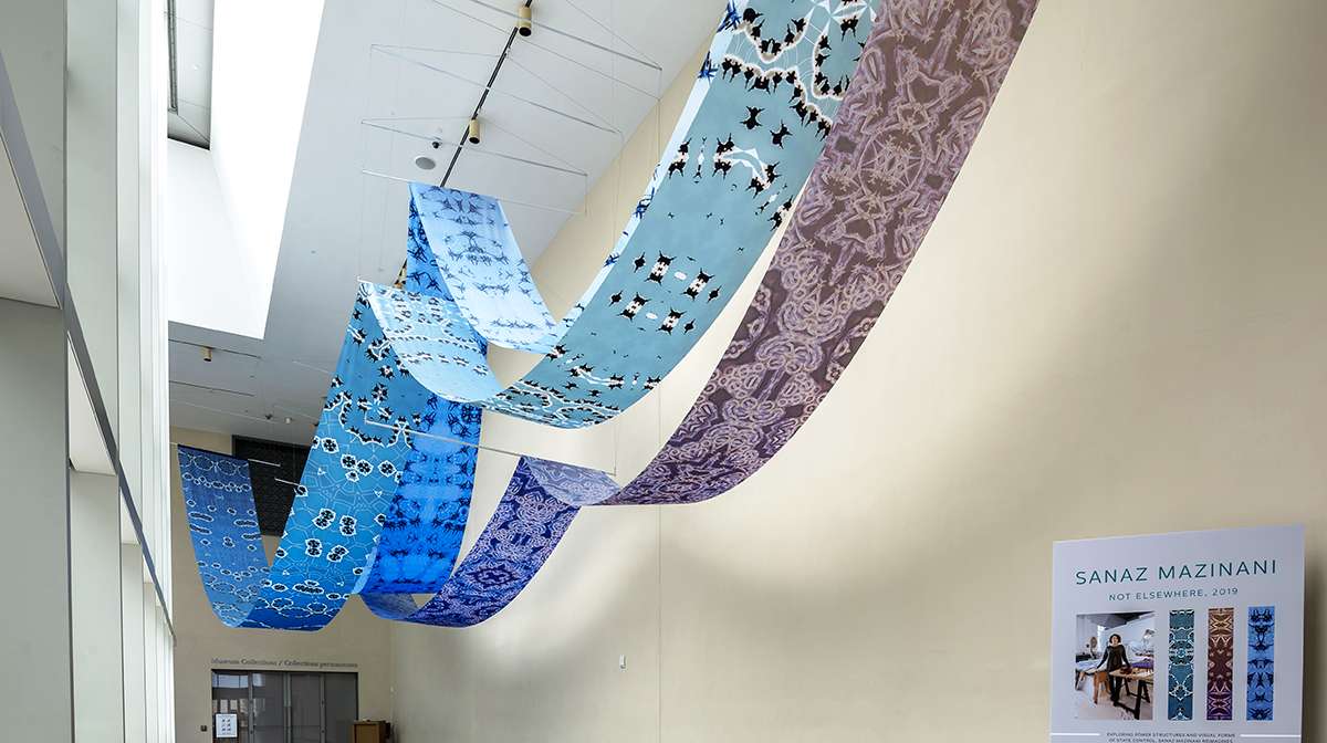 An art installation featuring large-scale fabric scrolls draped across the Museum’s atrium.