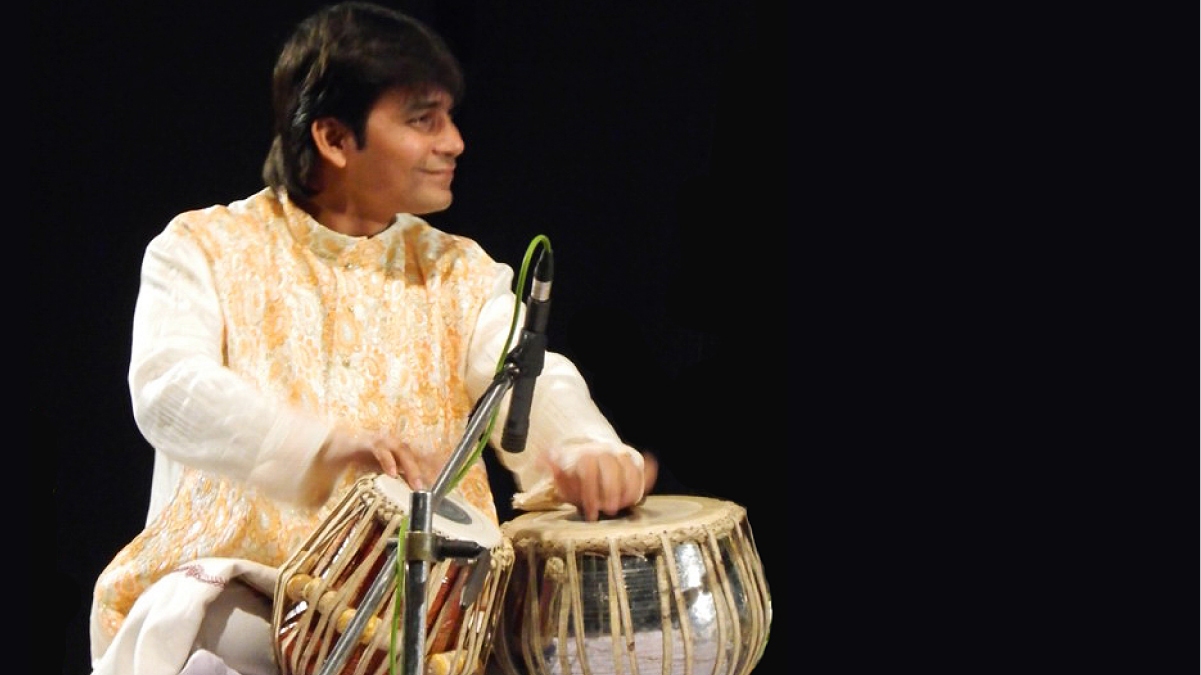 Sri Soumen Nandy, dressed all in white, plays the table drums.