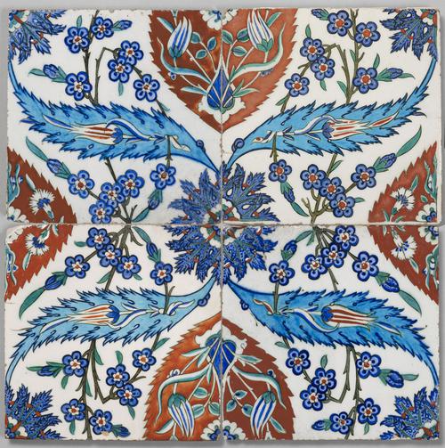 A panel of four ceramic tiles, each decorated with floral designs. Painted in red, turquoise, blue, sage and green, against a white opaque background.   