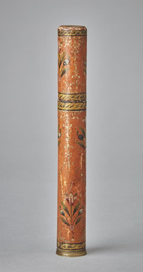 Cylindrical pen holder painted with floral designs and gold accents on orange background. 