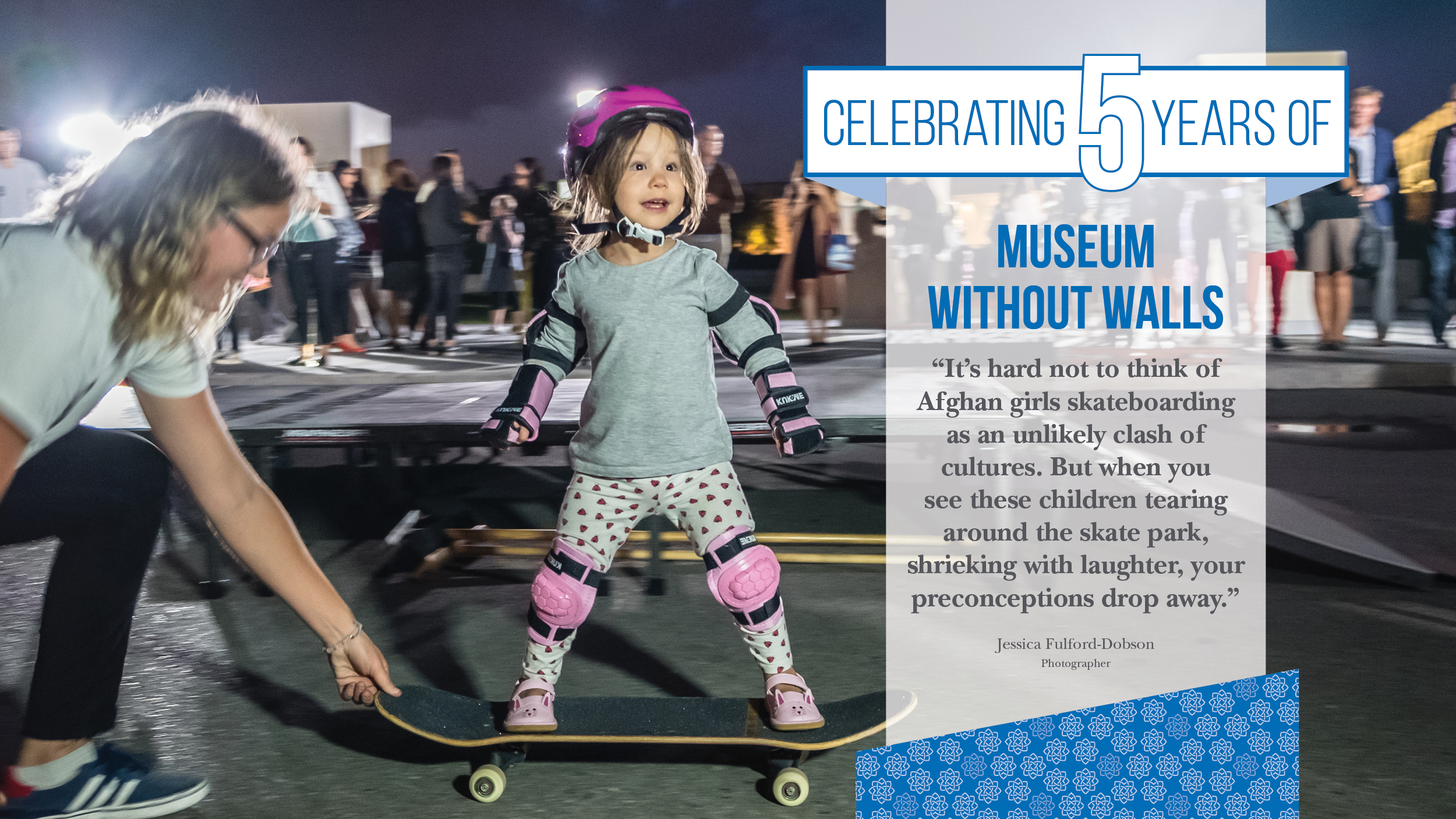 A woman steadies an excited little girl on a skateboard.