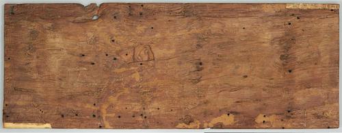 A large rectangular wooden panel. The back is uncarved, marked only by small holes and the natural texture of the wood. There is a larger hole in the upper left.